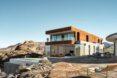 two-story home with concrete base and large deck
