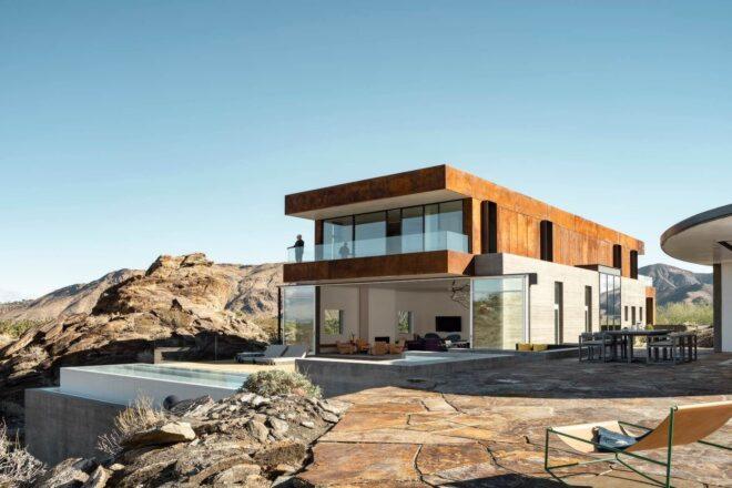 two-story home with concrete base and large deck