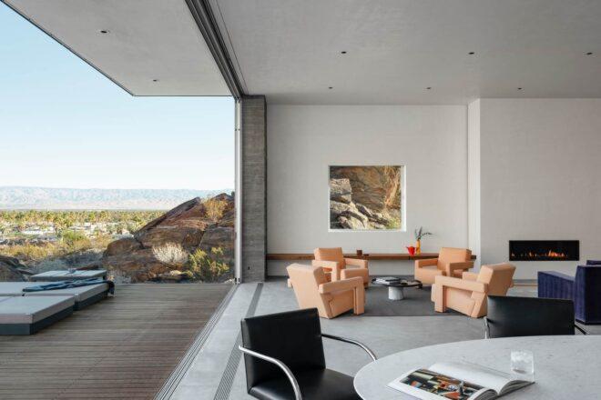 living area connected to an outdoor deck via large opening