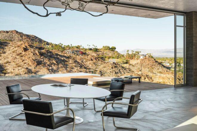 round dining table with seating looking out over hilly landscape