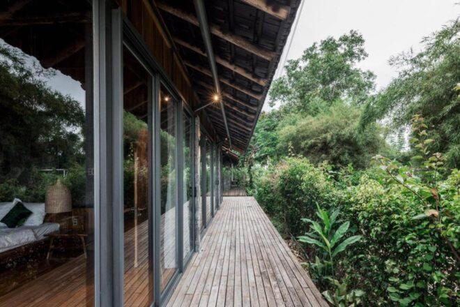 bungalow with glass wall and narrow wood balcony