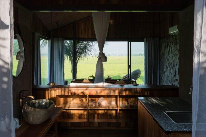 dark interior living space with window looking out over landscape