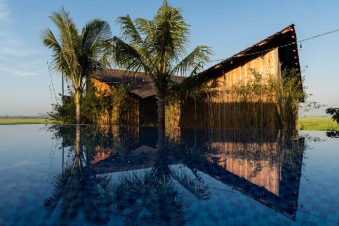 timber bungalow beside a pool