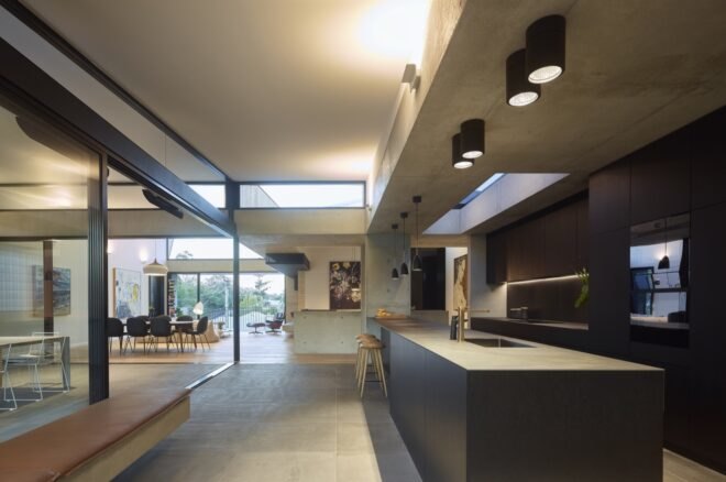 dark gray kitchen in room with many windows