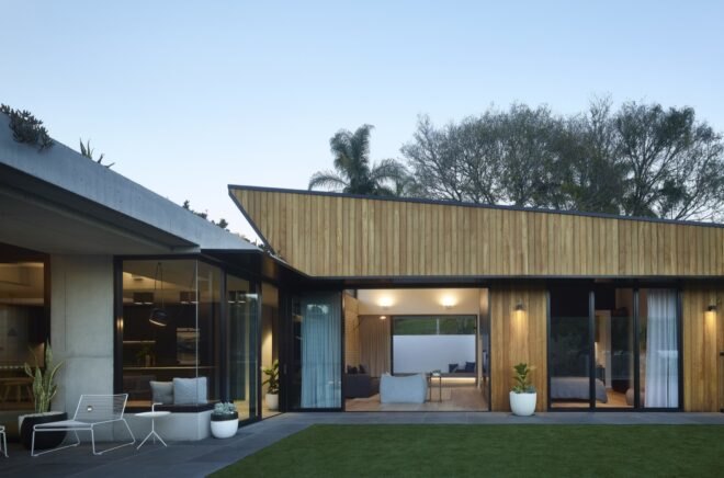 home extension with black and light wood cladding