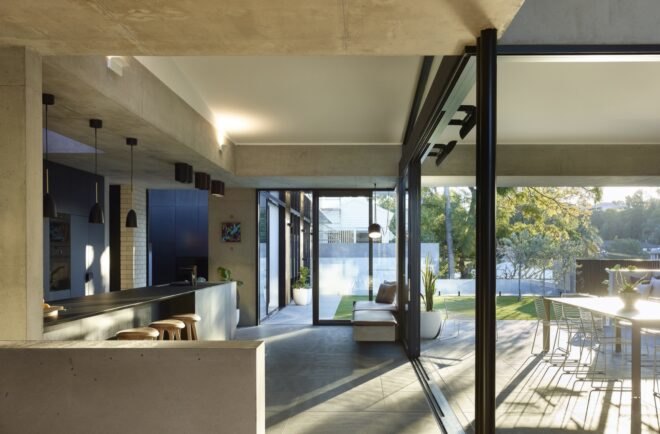 glass walls connecting outdoor dining set and indoor kitchen