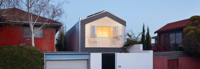 tall white home with gabled roof