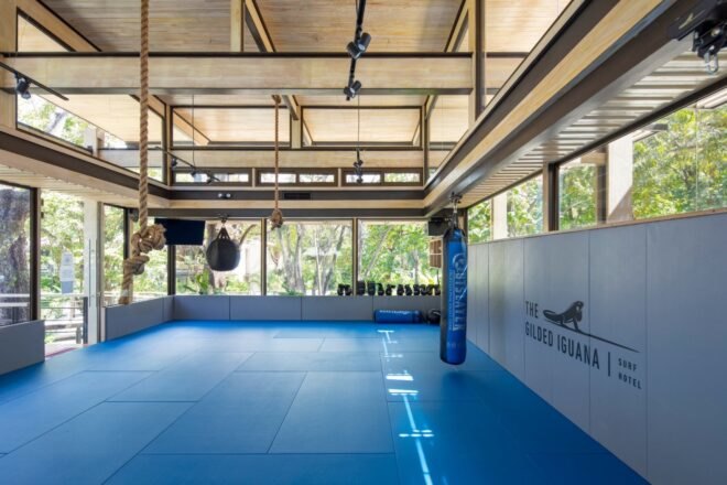 large interior space with bright blue flooring and glass walls