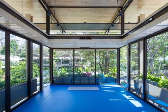 large interior room with all glass walls and blue floors