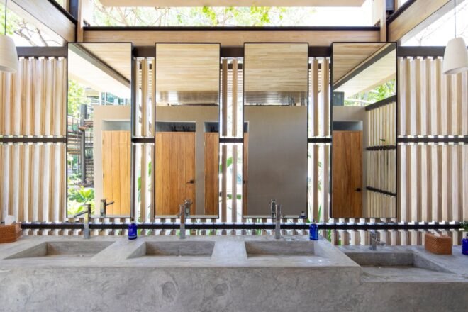 large, modern bathroom with long countertop and various sinks