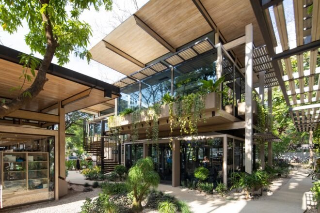 glass building surrounded by greenery
