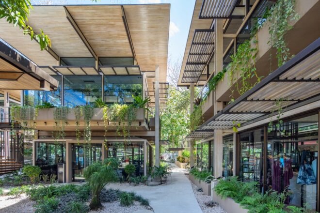 glass and metal building with a front courtyard