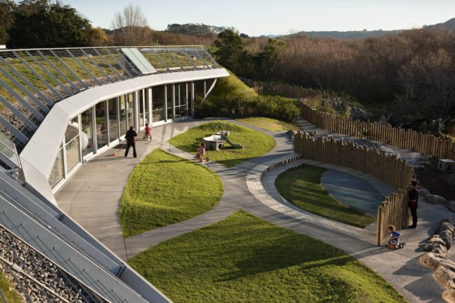 a curved building surrounded by greenery