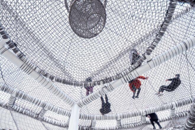kids playing on a netted playground