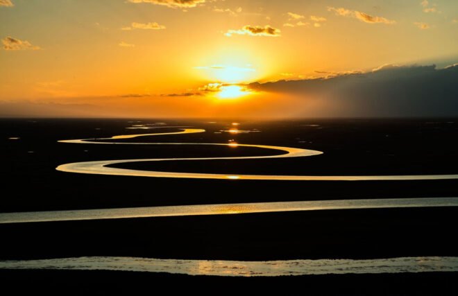 sun setting over a river