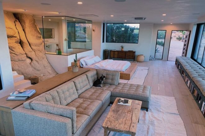 expansive living space with sofa and bed in background