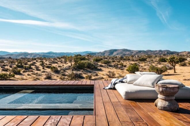 open-air wooden deck with lounge space and pool