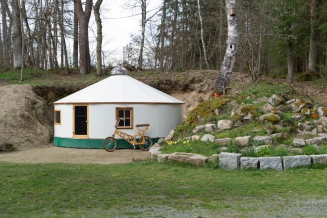 round white yurt surrounded by greenery