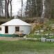 round white yurt surrounded by greenery
