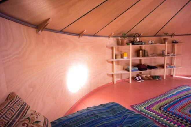 round living space with warm wood interior