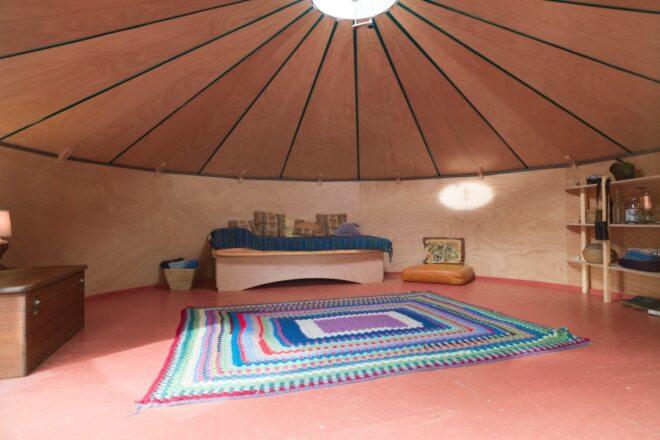 round living space with colorful rug