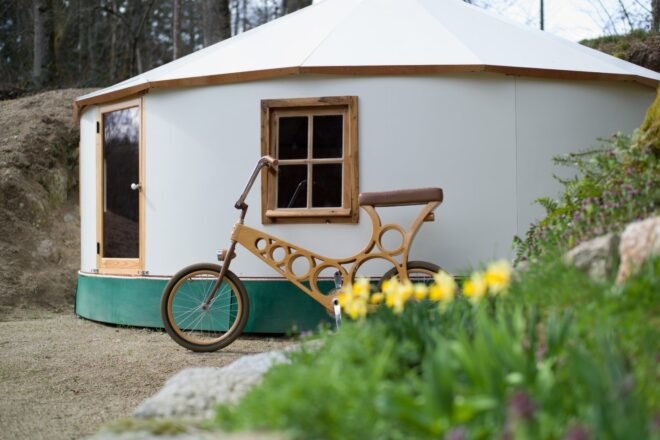 bicycle leaning up against a white yurt