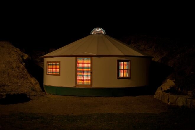 evening image of yurt illuminated at night