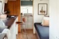 bench seating and a countertop inside an airstream trailer