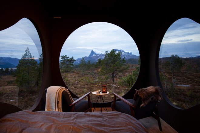 two chairs and small table near a round window
