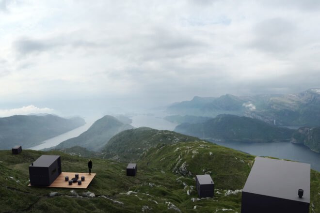 black cabins on a mountainous landscape