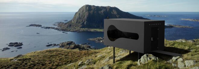 black cubic cabin overlooking sea