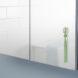 green toothbrush hanging on a mirror
