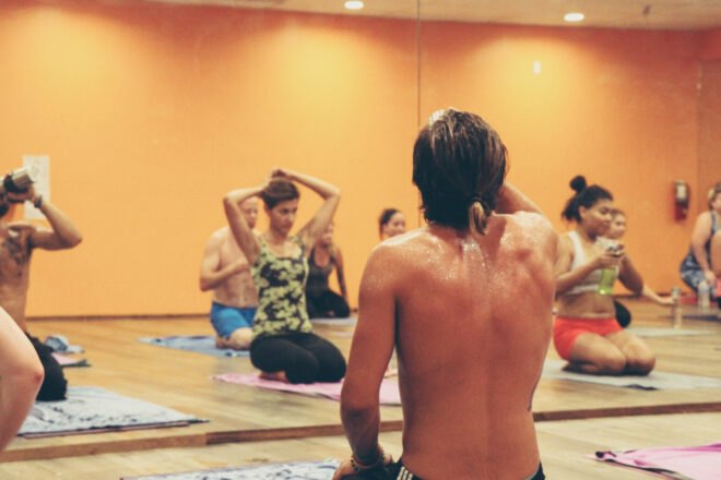 a hot yoga studio with a sweaty person in the foreground