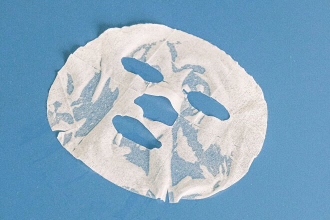 a white sheet mask on a blue background