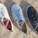 white, blue, and black boat shoes on sand
