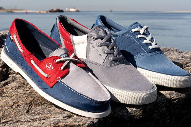 red, gray and blue boat shoes on a rock with water in the background