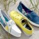 white, yellow and dark blue boat shoes on sand