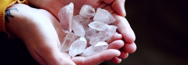 two hands put together to hold clear crystals