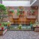 brick wall with planters filled with flowers
