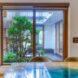 wood dining table near sliding glass door leading to a courtyard