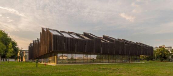 elongated timber building with many roofs