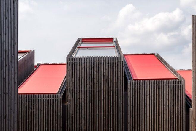 three tower-like structures with red coverings