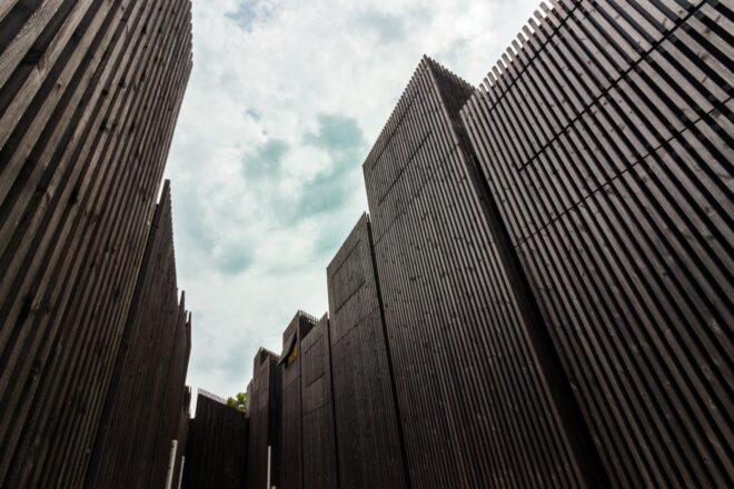 large building clad in dark timber slats