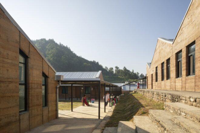 rammed earth buildings with jagged rooflines