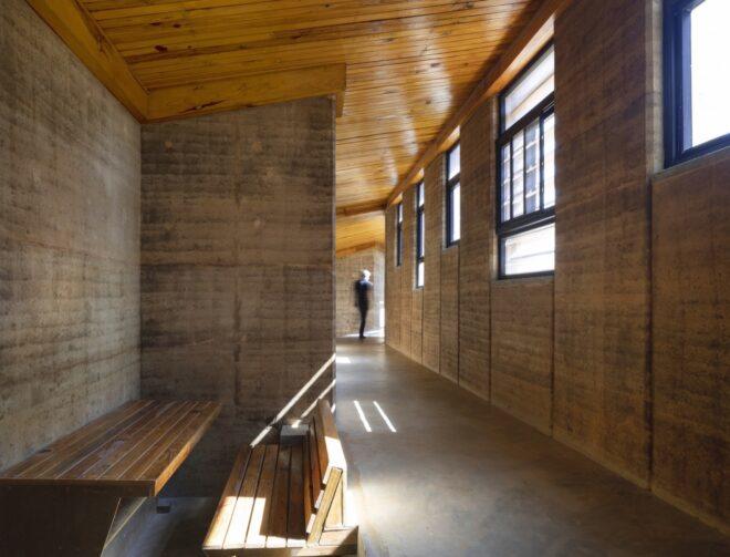 long hallway with rammed earth walls
