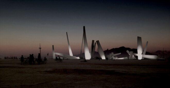 rendering of wind turbine blades in the desert lit up at night
