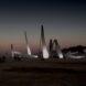 rendering of wind turbine blades in the desert lit up at night