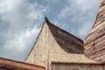 bird perched on pitched roof