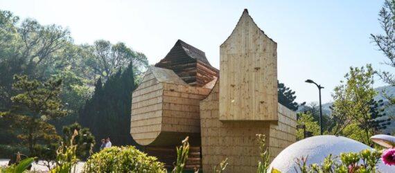 wooden structure with several volumes with sharply pitched roofs