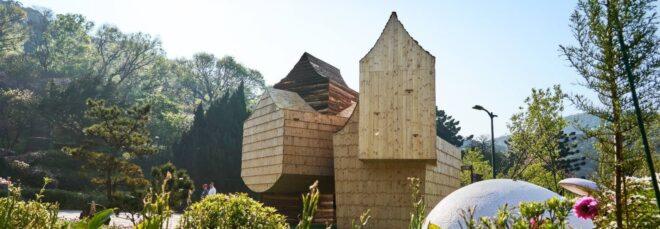 wooden structure with several volumes with sharply pitched roofs